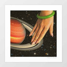 Load image into Gallery viewer, Cosmic Spin artwork featuring a woman's hand seamlessly integrated with Saturn's rings, creating a surreal and space-themed art piece. Perfect for modern decor and space enthusiasts looking for unique space-themed decor