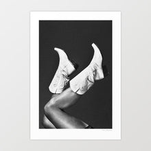 Charger l'image dans la galerie, Step into the mysterious allure of 'These Boots - Noir,' a captivating artwork blending the wild spirit of the West with cinematic noir aesthetics. Immerse yourself in the enigmatic world of a cowgirl adorned in pristine white rodeo boots, set against a striking black and white backdrop. Explore the juxtaposition of light and shadow, tradition and intrigue, in this evocative portrayal of Western mystique. Discover the essence of adventure and elegance