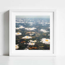 Load image into Gallery viewer, "Eggy Clouds" by Vertigo Artography - a surreal landscape art piece featuring clouds resembling fried eggs. Perfect for contemporary and whimsical art lovers. Unique nature inspired wall art with a touch of whimsy for sale.